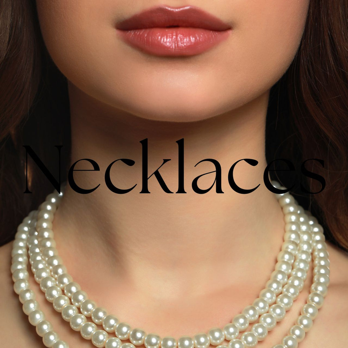 Necklace Collection featuring gold and silver cross necklaces, pearl link chains, crystal-accented chains, and sun-and-moon pendant necklaces arranged on a soft cream satin background with magnolia and rose flowers. 
