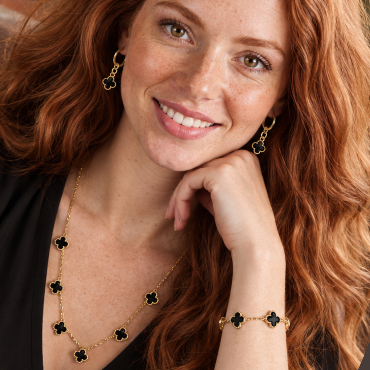 Jackson Avenue Collection black and gold clover bracelet, necklace, and earrings
