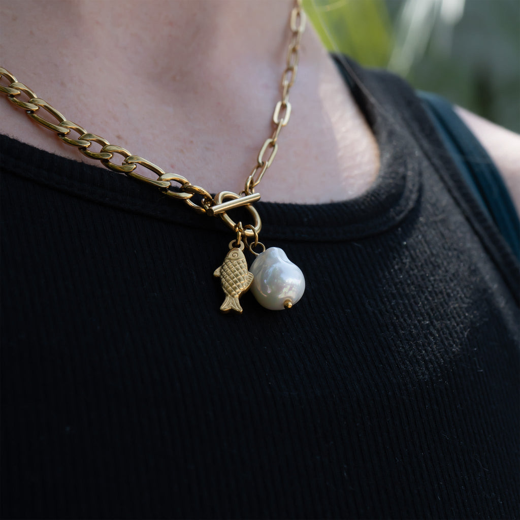 Gold pearl carabiner necklace worn on model