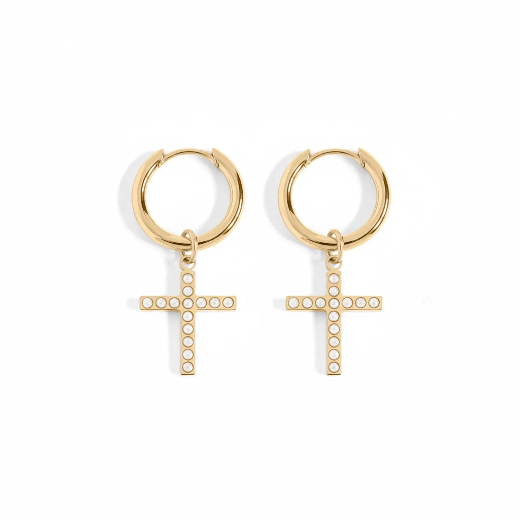 A pair of gold hoop earrings with dangling cross charms, each adorned with small clear stones, shown on a clean white background.