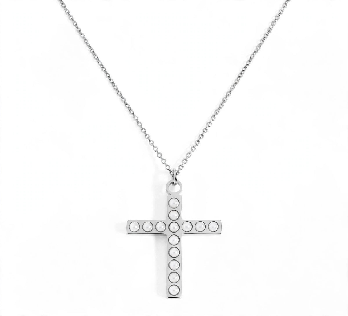 A silver cross pendant necklace with small circular pearl stones set along the arms, suspended from a delicate silver chain on a white background.