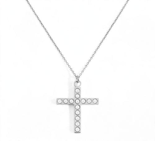 A silver cross pendant necklace with small circular pearl stones set along the arms, suspended from a delicate silver chain on a white background.