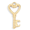 Gold key-shaped charm with a heart design on a white background