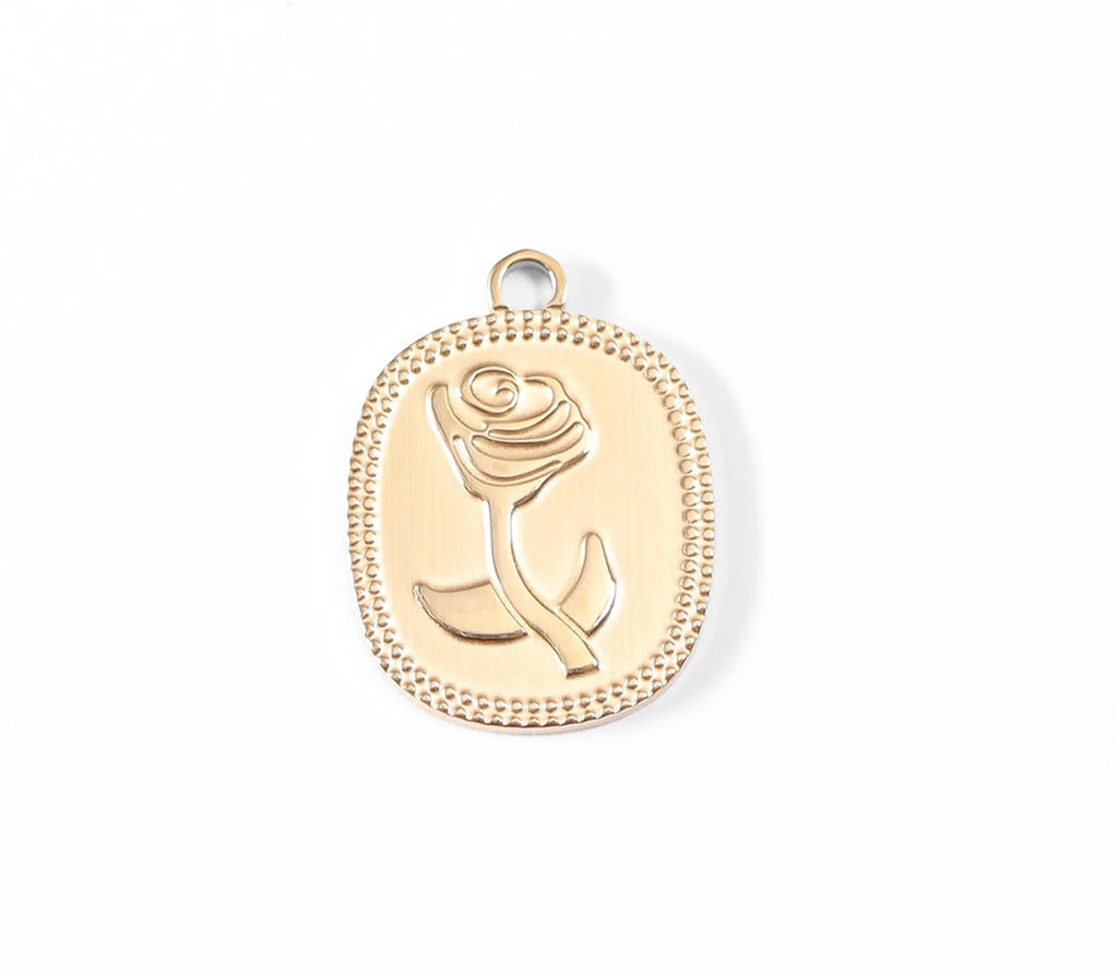 A gold oval pendant featuring an embossed rose design and a beaded border, shown on a clean white background.
