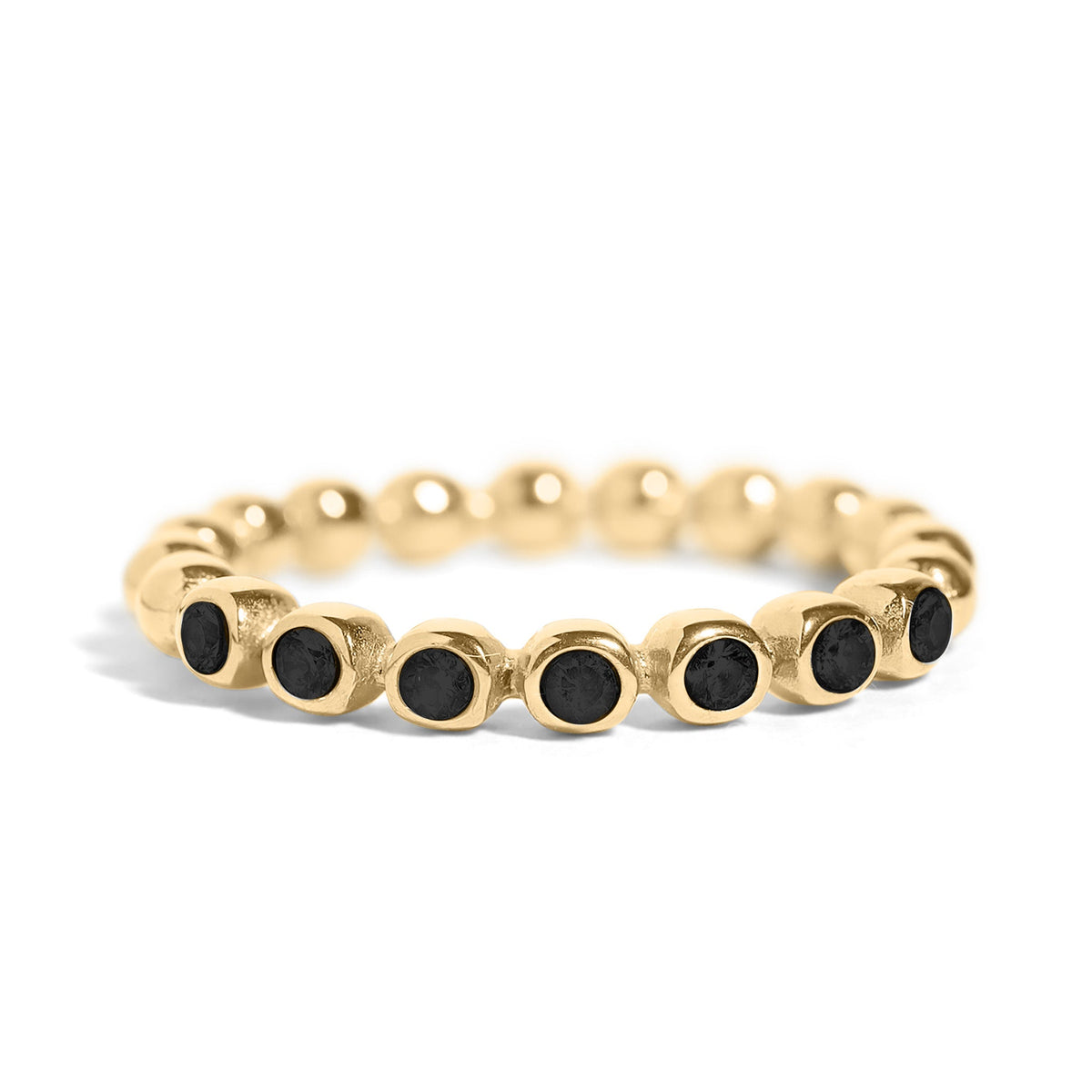 Gold ring with black stones on a white background