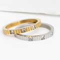 Nicole Stacking Ring in gold with sculptural interlocking band and sparkling stone accent, shown on a white background from Garden District Jewelry