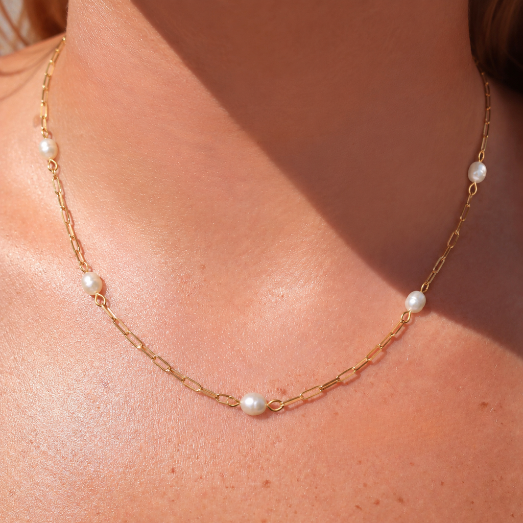 The Josephine Street Station Pearl Necklace in gold, a 16-inch pearl station necklace from Garden District Jewelry.
