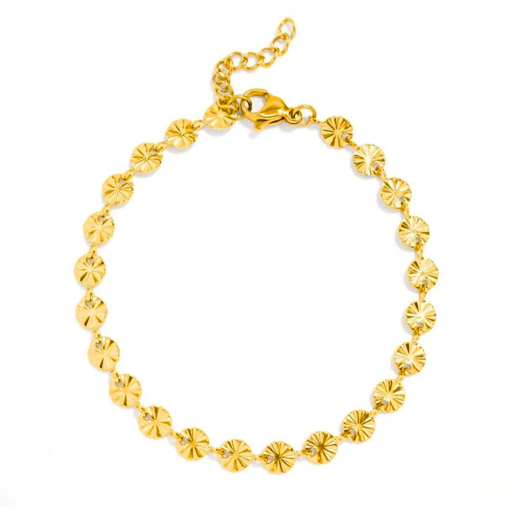 A gold chain bracelet made of small, round, textured disc links arranged in a circle, featuring a lobster clasp and extender chain, shown on a plain white background.