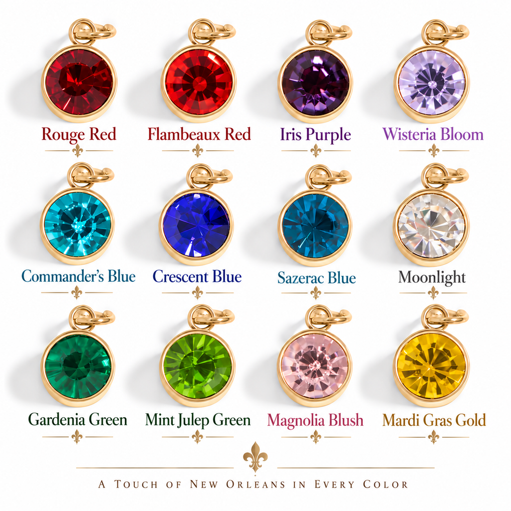 A color-options display showing twelve oval pendant charms with gold-tone settings and faceted gemstones in different colors, each labeled with a name such as Rouge Red, Flambeaux Red, Iris Purple, Wisteria Bloom, Commander's Blue, Crescent Blue, Sazerac Blue, Moonlight, Gardenia Green, Mint Julep Green, Magnolia Blush, and Mardi Gras Gold. Text at the bottom reads 'A TOUCH OF NEW ORLEANS IN EVERY COLOR' with a fleur-de-lis.