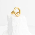 Gold ring on a white marble surface