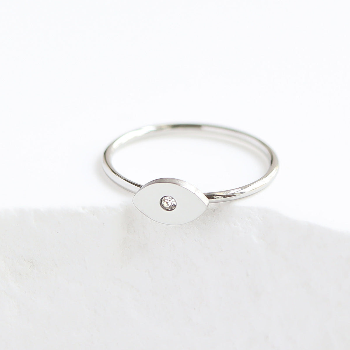 Silver evil eye ring with a small diamond on a white background