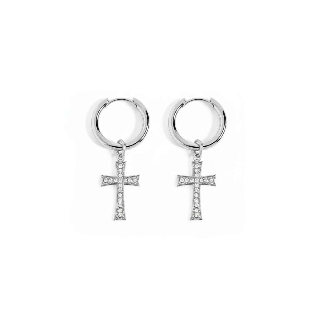 A pair of silver hoop earrings with small cross pendants paved with clear stones, shown on a plain white background.