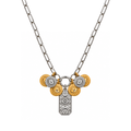 The Delphine Necklace from A silver paperclip chain necklace featuring a multi-charm pendant with gold and silver evil eye coins and a central silver celestial pendant, shown on a plain white background.arden District Jewelry.
