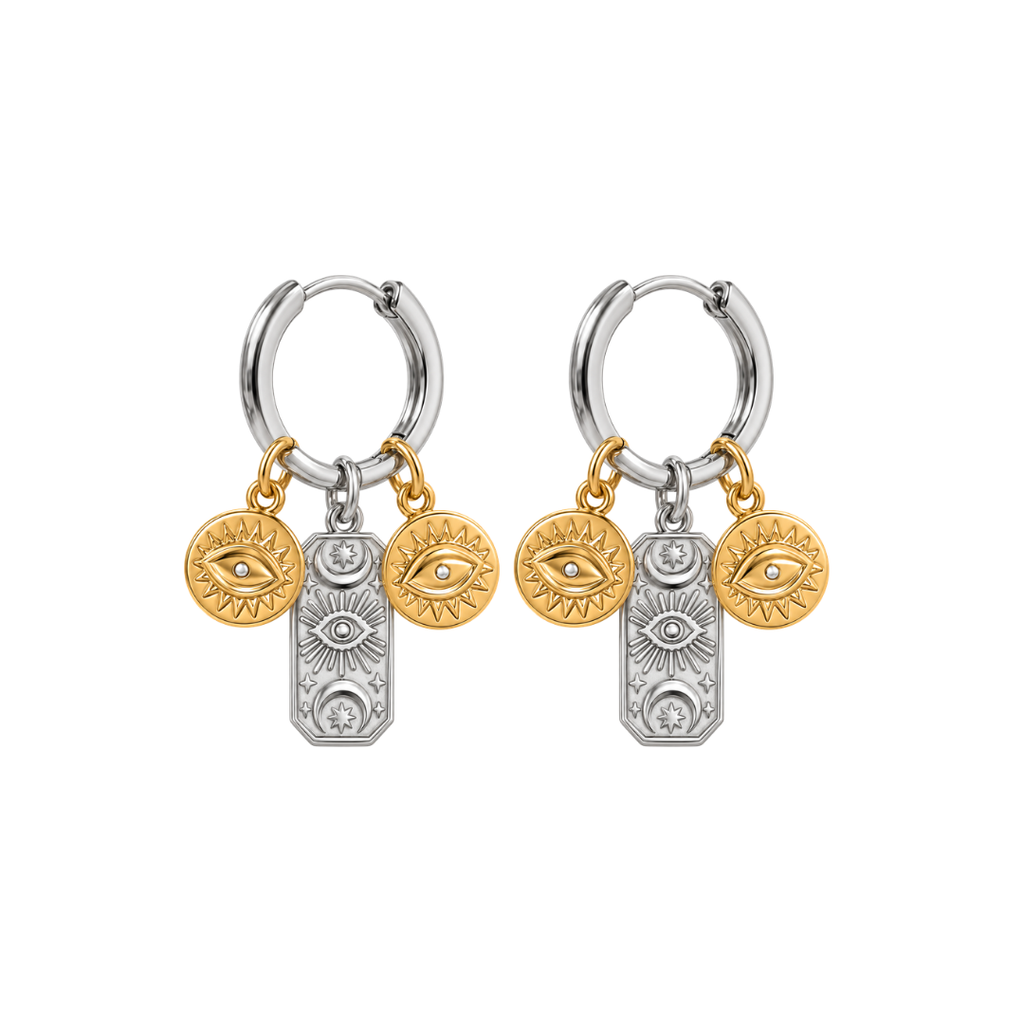 A pair of silver and gold hoop earrings with dangling eye and sun motif charms, shown on a plain white background.